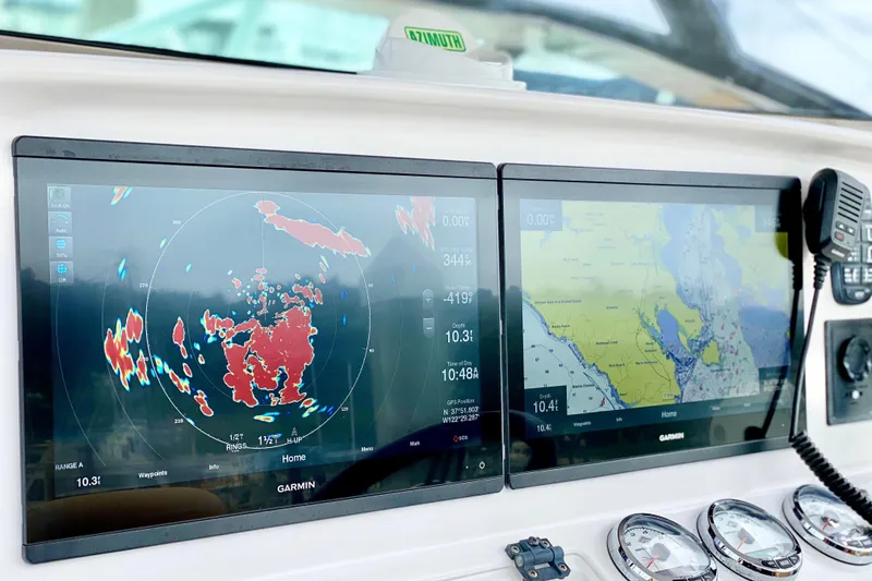 Dashboard of a 2006 Donzi 38 ZSF boat with Garmin navigation displays.