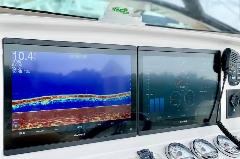 Dashboard of a 2006 Donzi 38 ZSF with Garmin navigation displays and controls.