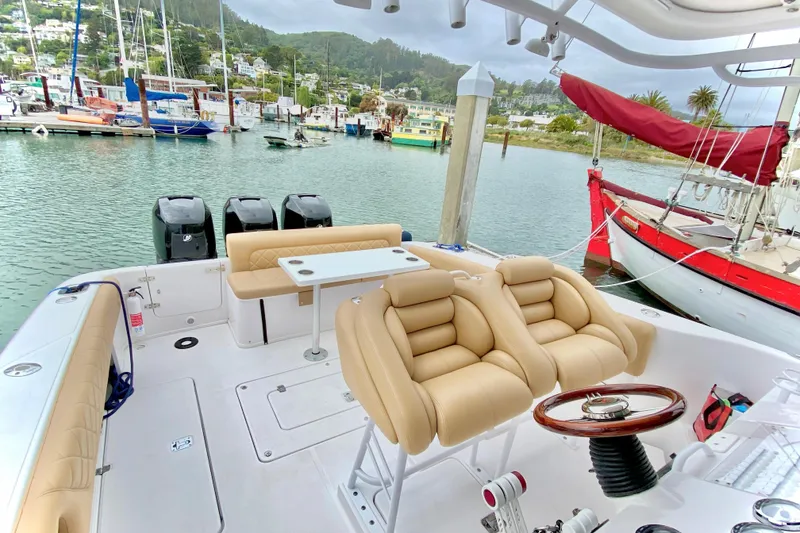 2006 Donzi 38 ZSF boat interior with beige seating, docked in a scenic marina.