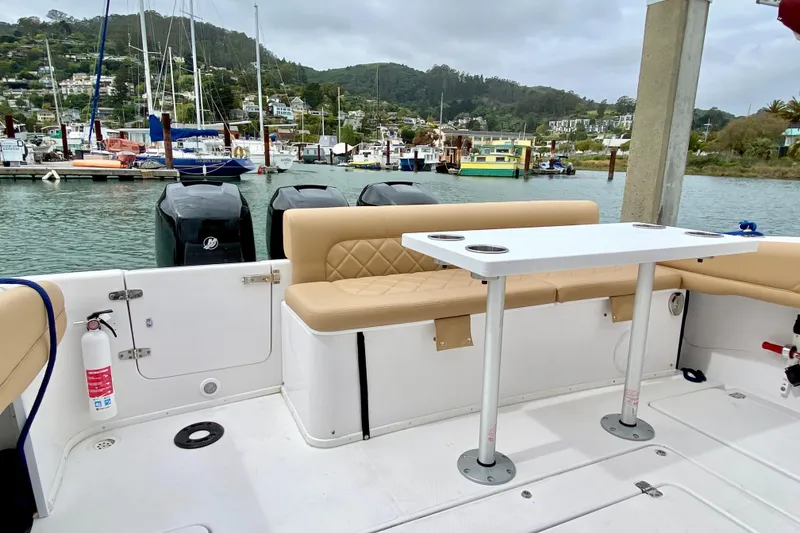 2006 Donzi 38 ZSF boat interior with seating and table, docked at a marina.