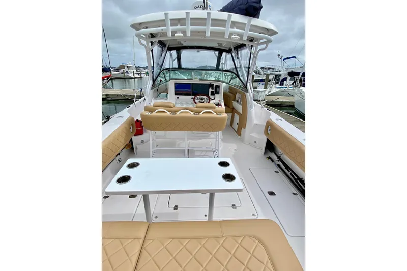 2006 Donzi 38 ZSF boat interior with beige seating and white table at marina.