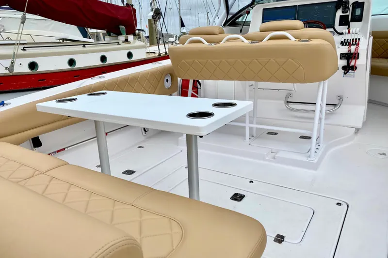 2006 Donzi 38 ZSF boat interior with beige seating and white table.