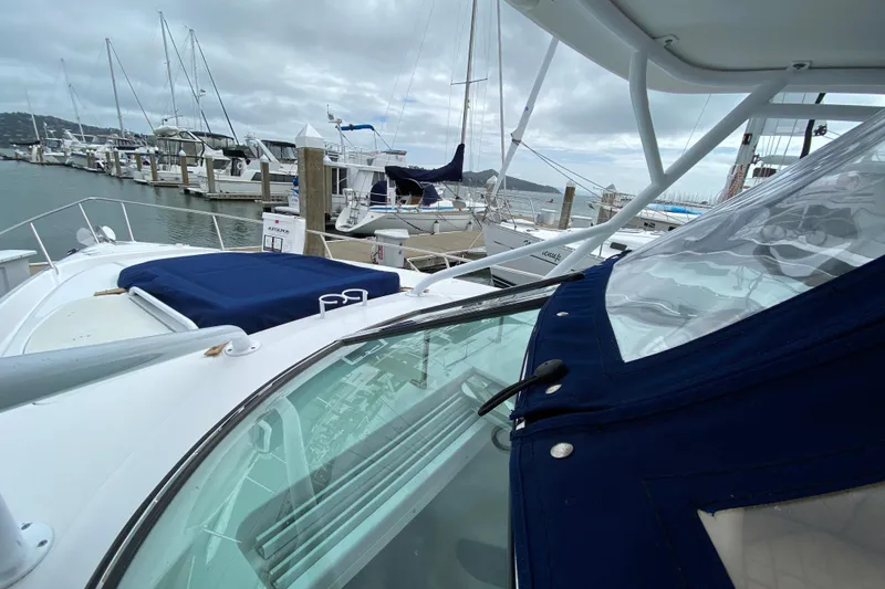 2006 Donzi 38 ZSF boat docked at a marina under cloudy skies.