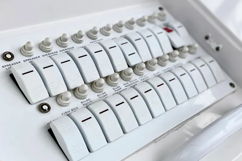 Control panel of a 2006 Donzi 38 ZSF boat with labeled switches and toggles.