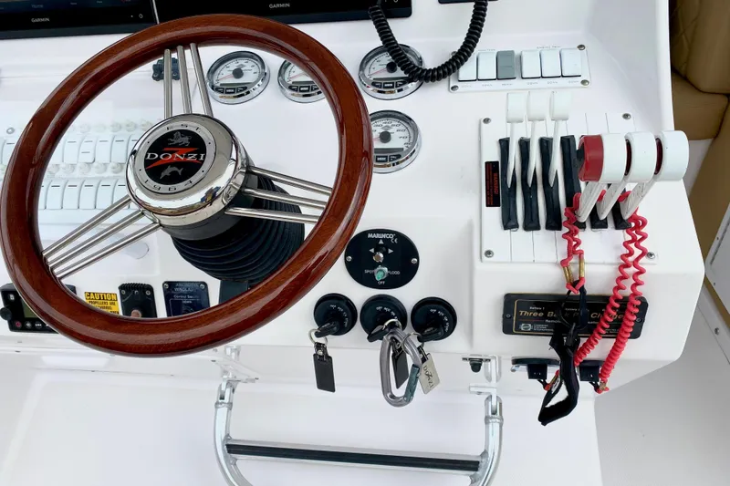 Steering wheel and controls of a 2006 Donzi 38 ZSF boat cockpit.