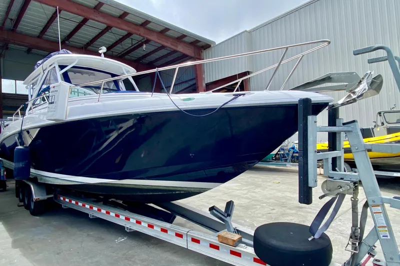2006 Donzi 38 ZSF boat on trailer in a warehouse setting.