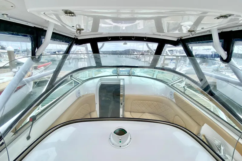 Interior view of 2006 Donzi 38 ZSF boat with tan seating and clear windshield.