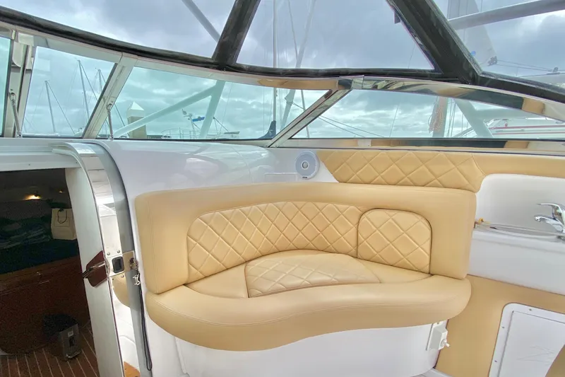 Luxurious interior of a 2006 Donzi 38 ZSF boat with beige quilted seating.