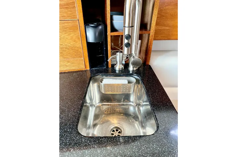 Stainless steel sink in 2006 Donzi 38 ZSF boat kitchen with modern faucet.