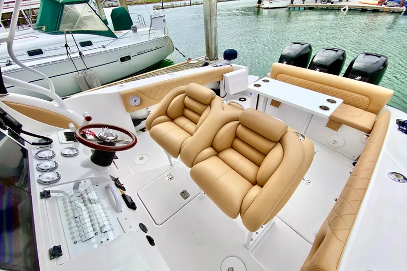 2006 Donzi 38 ZSF boat interior with tan leather seating and modern dashboard.