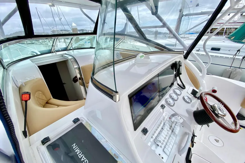 2006 Donzi 38 ZSF boat cockpit with modern navigation equipment and luxurious seating.