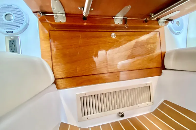 Interior view of a 2006 Donzi 38 ZSF boat, featuring wood paneling and speakers.