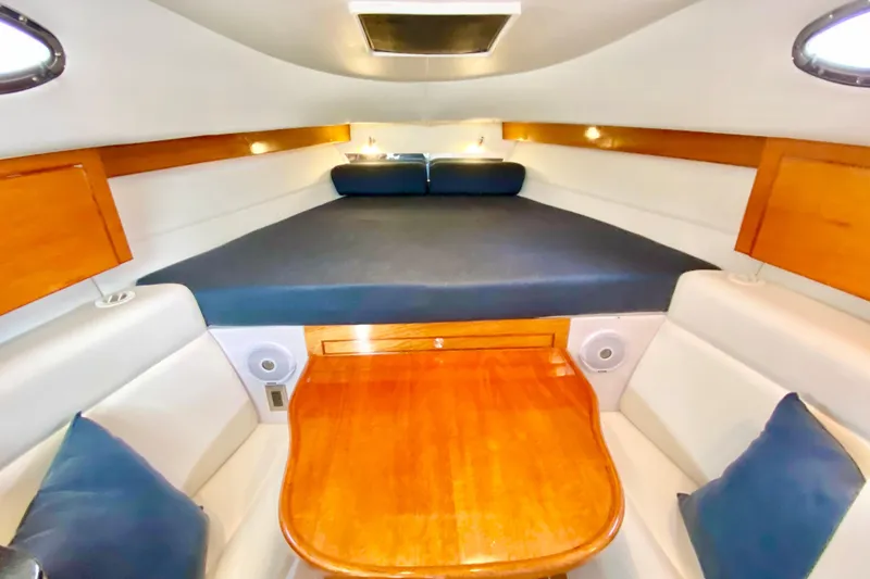 Interior cabin of a 2006 Donzi 38 ZSF boat with wood accents and seating.