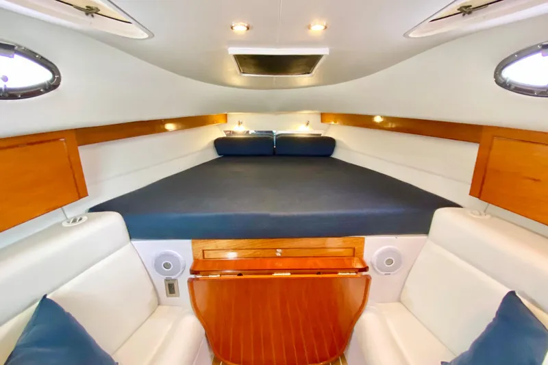 Interior of 2006 Donzi 38 ZSF boat with cozy seating and wooden accents.