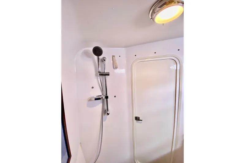Shower area inside 2006 Donzi 38 ZSF boat, featuring modern fixtures and lighting.