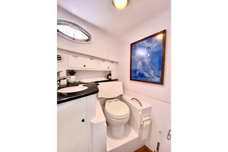 Luxurious bathroom interior of 2006 Donzi 38 ZSF boat with modern amenities.