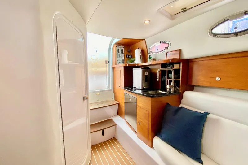 Interior of 2006 Donzi 38 ZSF boat with kitchenette and seating area.