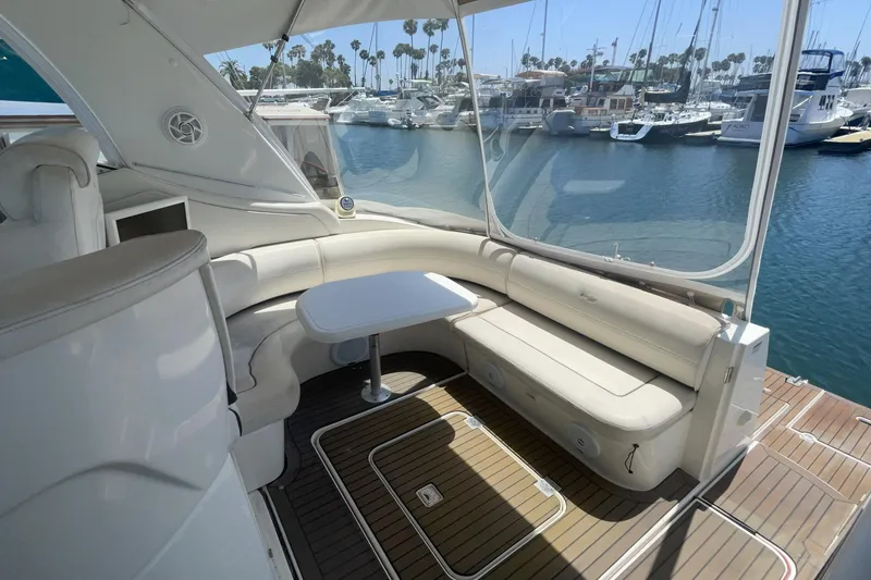 Luxurious 2006 Cruisers Yachts 370 Express interior with elegant seating and marina view.
