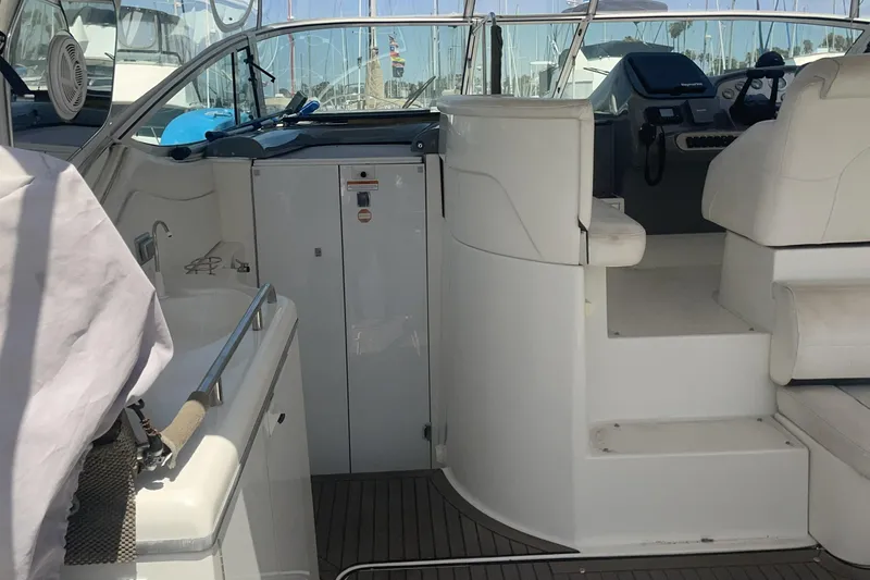 2006 Cruisers Yachts 370 Express interior with helm, seating, and sink area.