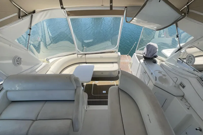 2006 Cruisers Yachts 370 Express interior with seating and table, overlooking water.