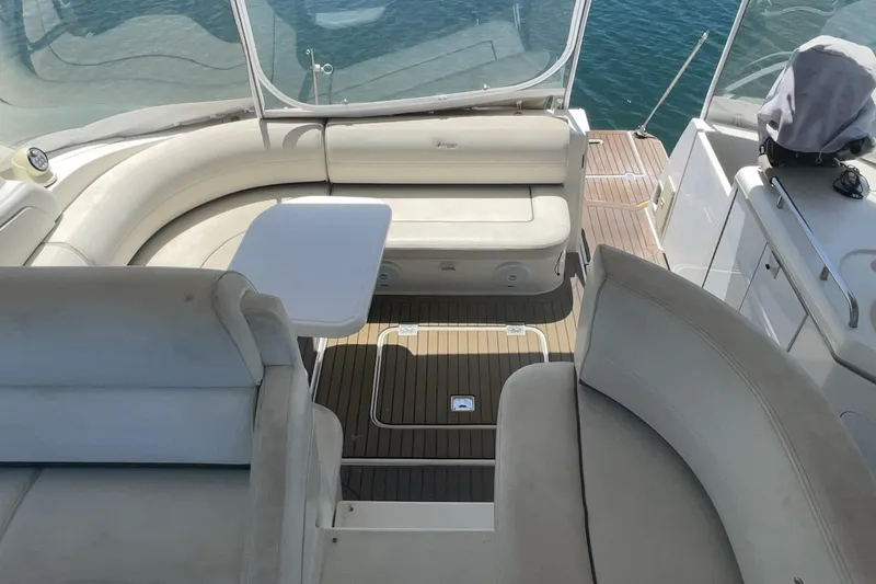2006 Cruisers Yachts 370 Express interior with seating and table on deck.