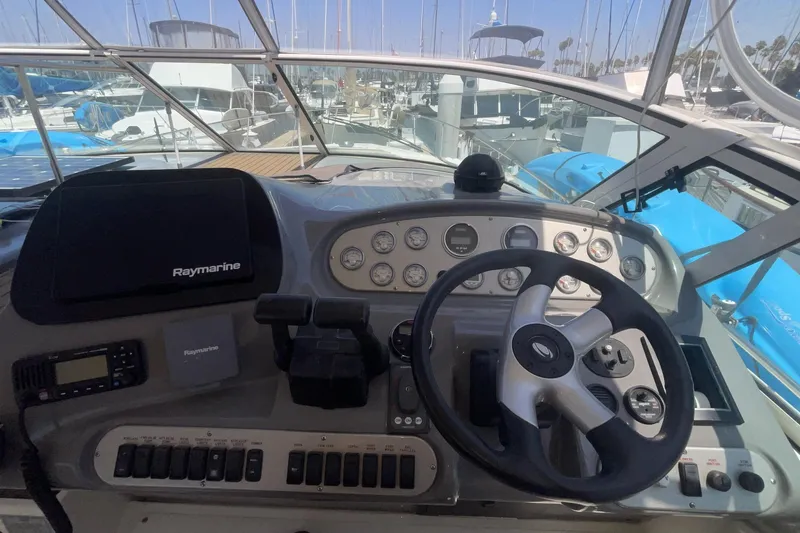 Helm of 2006 Cruisers Yachts 370 Express with Raymarine navigation system and steering wheel.