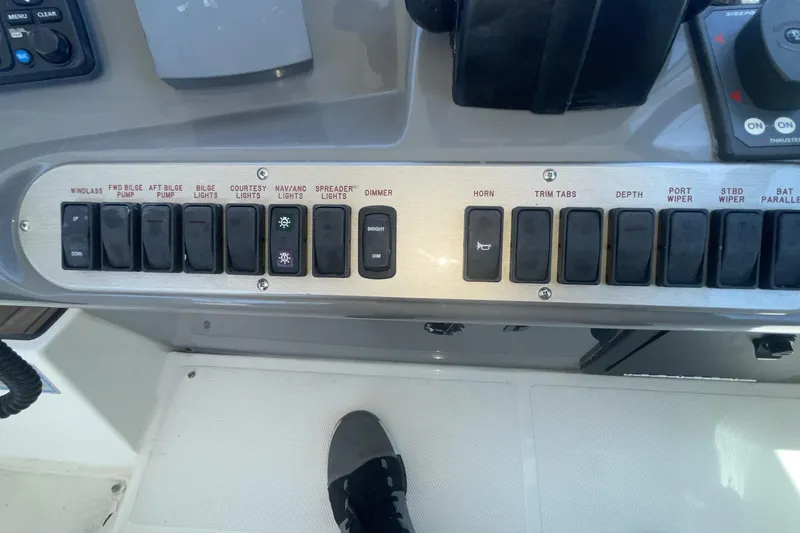 Control panel of a 2006 Cruisers Yachts 370 Express with labeled switches and buttons.