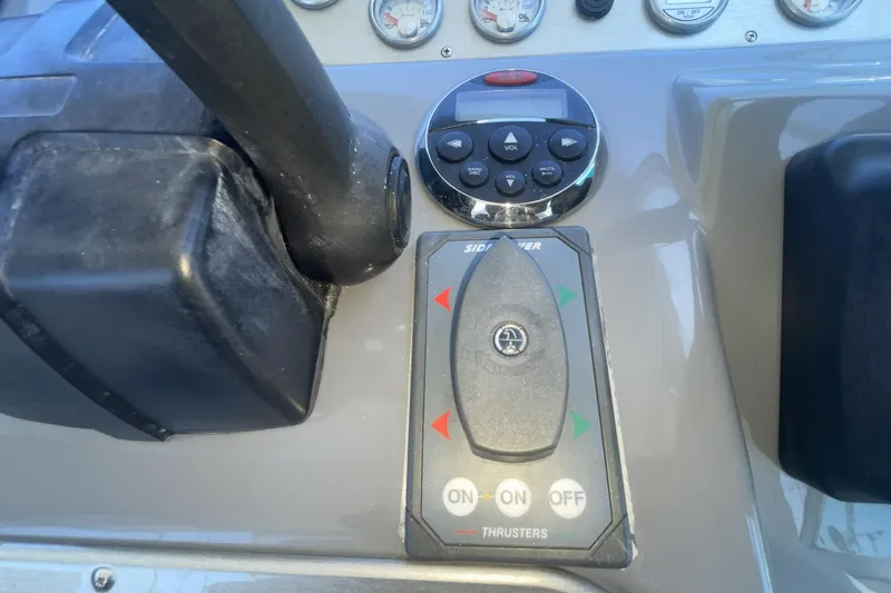 Control panel of a 2006 Cruisers Yachts 370 Express with thruster controls.