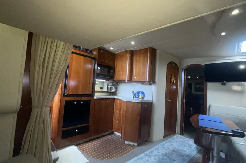 Interior of 2006 Cruisers Yachts 370 Express with wood cabinetry and modern amenities.