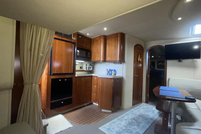 Interior of 2006 Cruisers Yachts 370 Express, featuring a cozy kitchen and dining area.