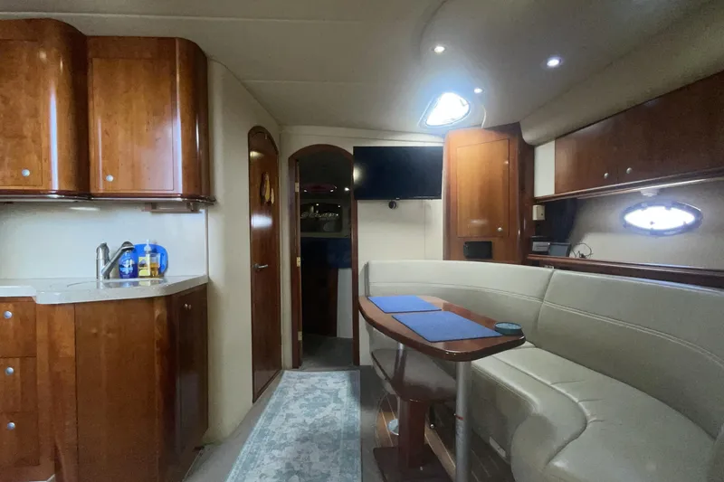 Luxurious interior of 2006 Cruisers Yachts 370 Express with elegant wood cabinetry and plush seating.