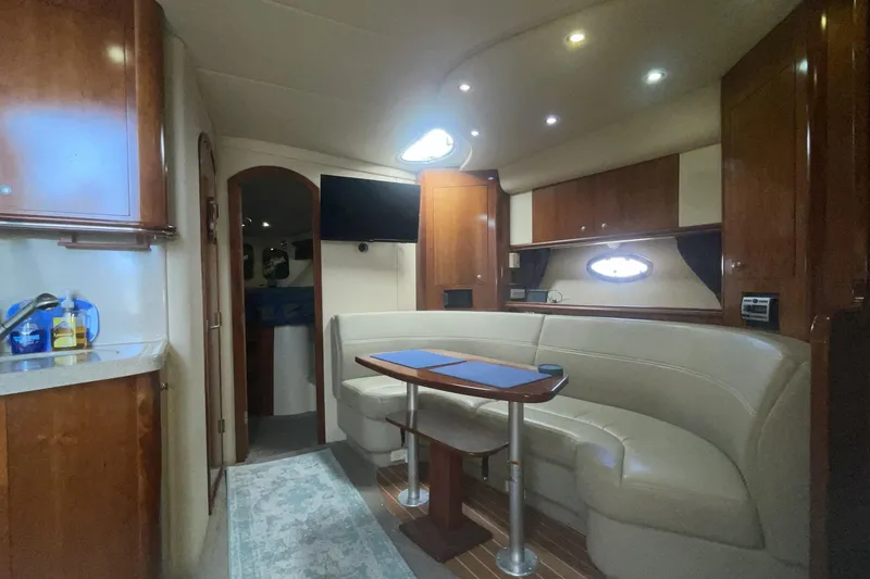 Interior of 2006 Cruisers Yachts 370 Express with elegant seating and wooden cabinetry.