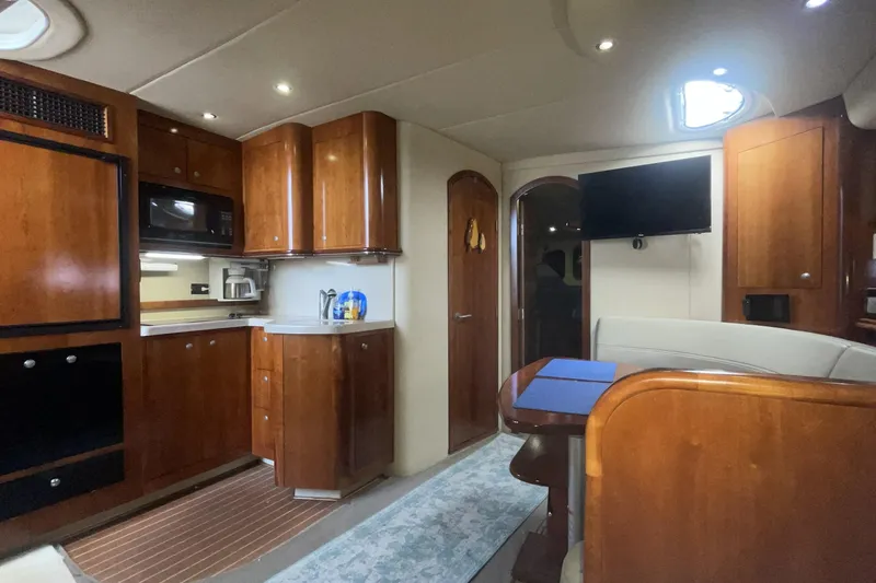 Luxurious interior of 2006 Cruisers Yachts 370 Express with wood cabinetry and modern amenities.