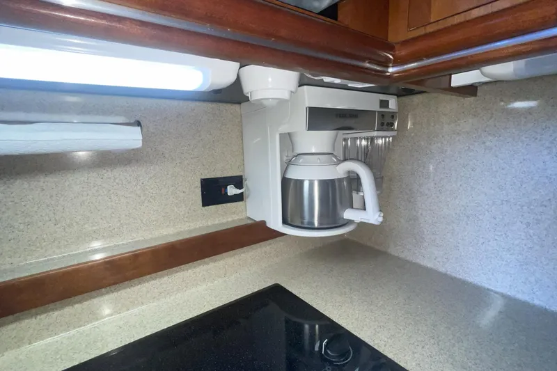 2006 Cruisers Yachts 370 Express kitchen with coffee maker and countertop.