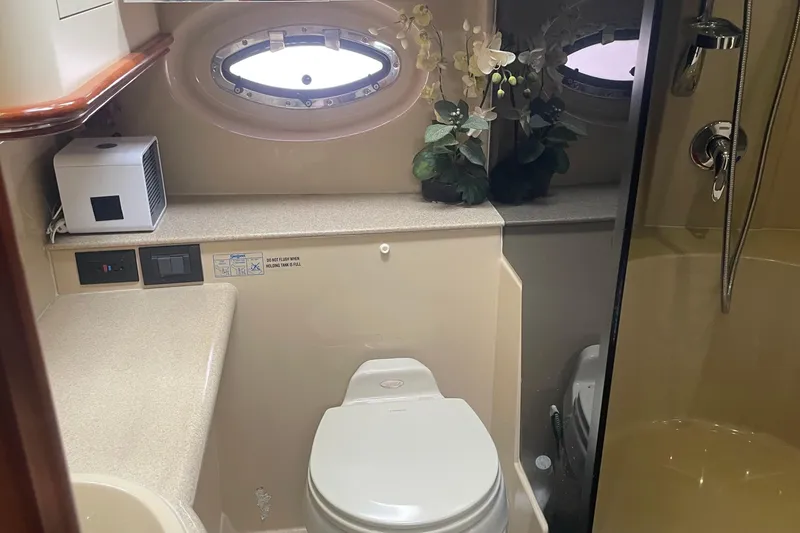 Bathroom interior of 2006 Cruisers Yachts 370 Express with shower and porthole window.