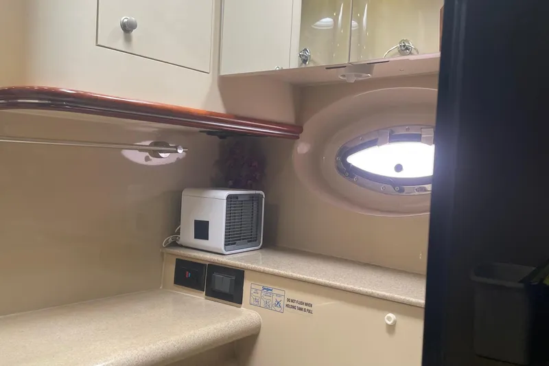 Interior of 2006 Cruisers Yachts 370 Express with porthole and countertop.
