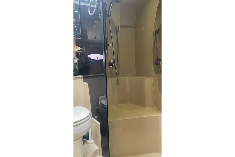 Bathroom interior of 2006 Cruisers Yachts 370 Express, featuring shower and toilet.