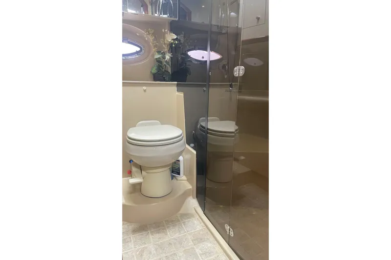 Bathroom interior of 2006 Cruisers Yachts 370 Express with toilet and glass shower.