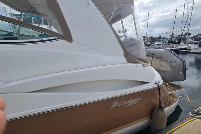 2006 Cruisers Yachts 370 Express docked at marina, showcasing sleek design and elegant lines.