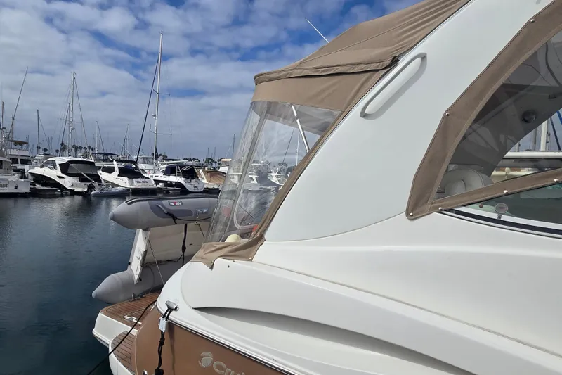 2006 Cruisers Yachts 370 Express docked in a marina with other boats.