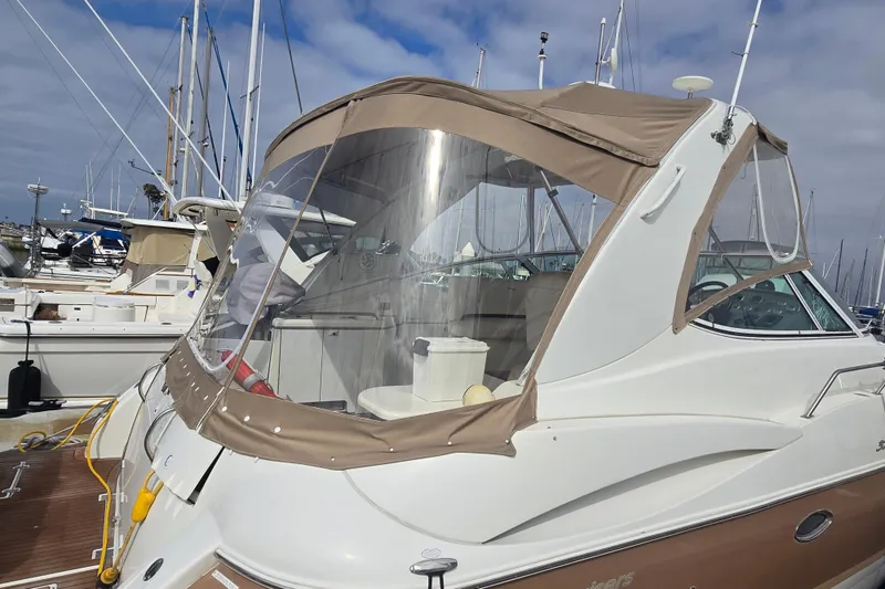 2006 Cruisers Yachts 370 Express docked at marina with beige canopy.