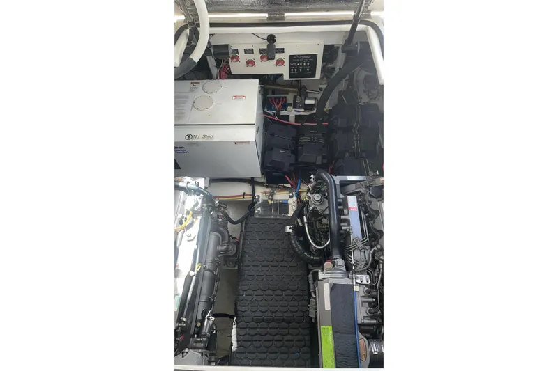 Engine compartment of 2006 Cruisers Yachts 370 Express, showcasing mechanical components and systems.