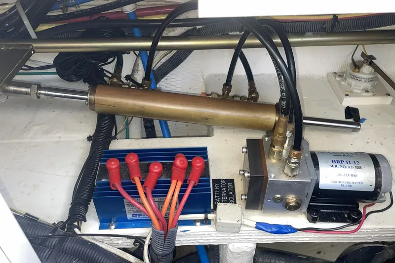 Engine compartment of a 2006 Cruisers Yachts 370 Express, showcasing hydraulic and electrical components.