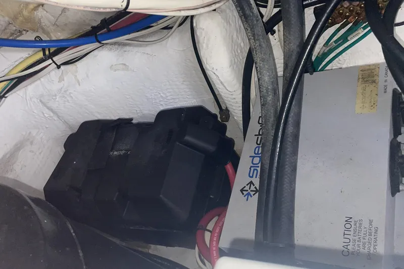 Electrical components and wiring inside a 2006 Cruisers Yachts 370 Express boat.