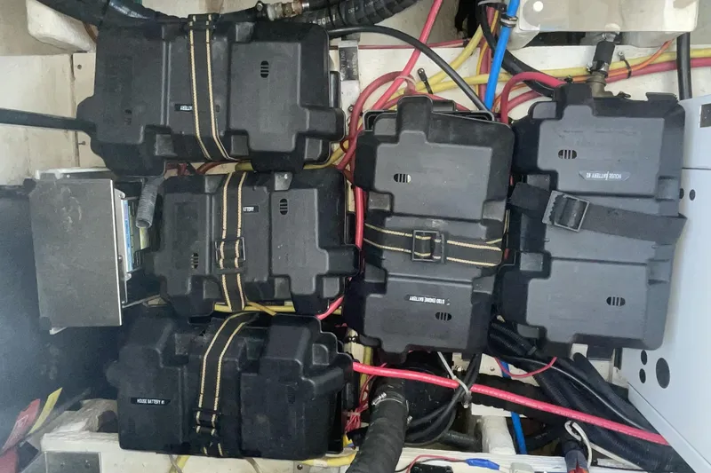 Battery compartment of a 2006 Cruisers Yachts 370 Express with secured black battery boxes.