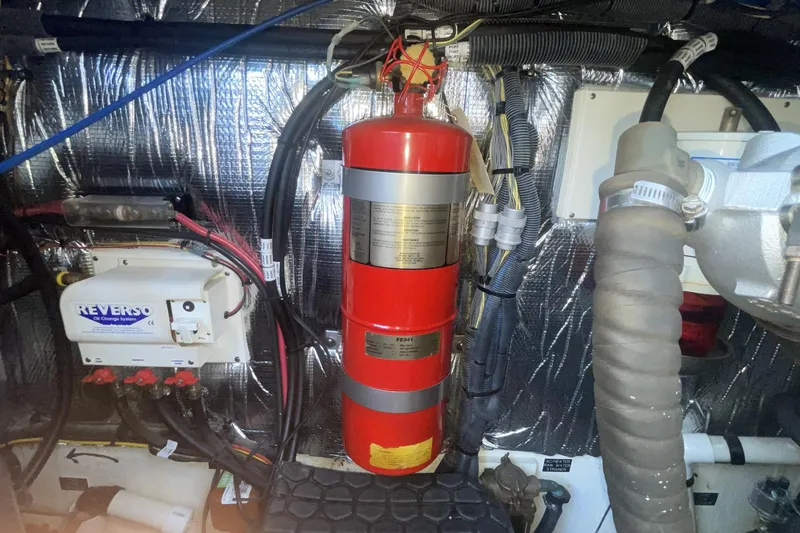 Engine room of 2006 Cruisers Yachts 370 Express with fire extinguisher and Reverso oil change system.