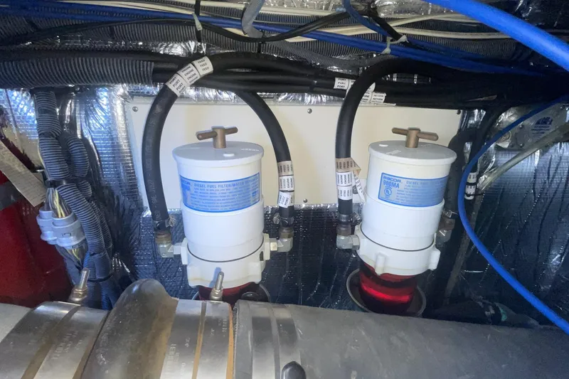 Engine compartment of 2006 Cruisers Yachts 370 Express with fuel filters and wiring.