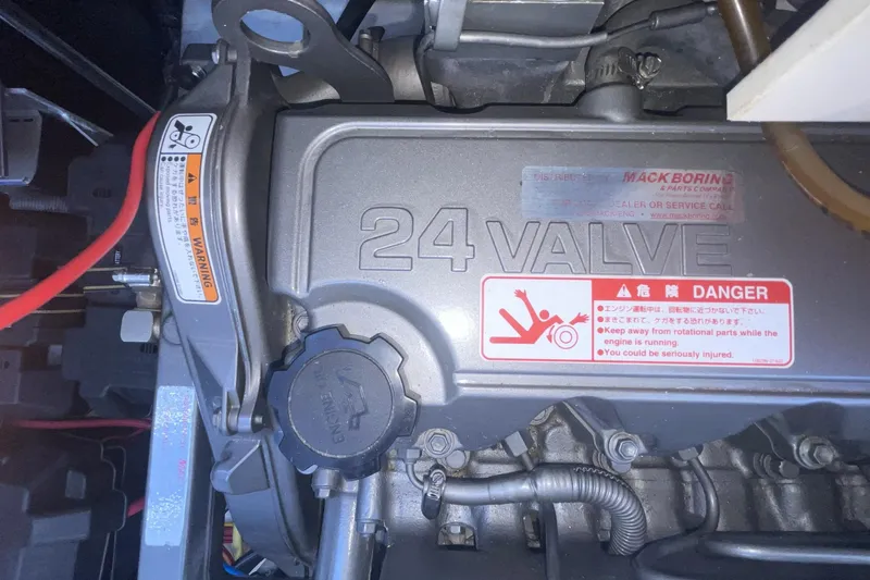 Engine compartment of a 2006 Cruisers Yachts 370 Express, featuring a 24-valve engine warning label.
