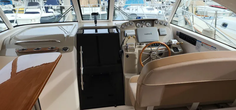 2012 Tiara Yachts 3100 Coronet helm with modern controls and luxurious seating.