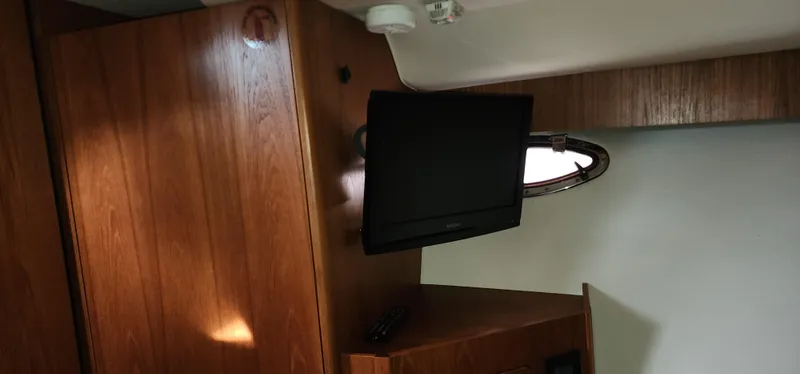 Interior of 2012 Tiara Yachts 3100 Coronet with TV and wooden cabinetry.